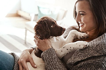 Dog_cuddling_woman